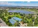 Stunning aerial view featuring tennis courts, a tranquil lake, and scenic mountain views in the distance at 4506 N Vrain St, Denver, CO 80212