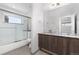 Bathroom featuring a double sink vanity, large mirror, and a tub with shower, and contemporary fixtures at 4506 N Vrain St, Denver, CO 80212