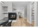 Open-concept living room featuring a modern fireplace and hardwood floors at 4506 N Vrain St, Denver, CO 80212