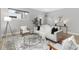 Bright living room featuring modern furnishings, a round glass coffee table, and a stylish area rug at 4506 N Vrain St, Denver, CO 80212