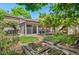 Backyard features a screened porch, sliding glass doors, brick patio, raised garden beds and beautiful mature landscaping at 2518 S Patton Ct, Denver, CO 80219
