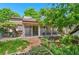 The backyard features a screened porch and sliding glass doors leading out to a brick patio with raised garden beds at 2518 S Patton Ct, Denver, CO 80219