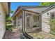Back exterior features siding, a sunroom, a brick patio, and a detached shed at 2518 S Patton Ct, Denver, CO 80219