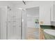 Bathroom with a glass shower and view into adjacent room at 2518 S Patton Ct, Denver, CO 80219