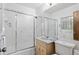 Clean bathroom with a shower over bath, vanity, and tiled walls at 2518 S Patton Ct, Denver, CO 80219