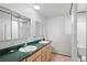 Bathroom with double sinks, tiled floors, and a shower at 2518 S Patton Ct, Denver, CO 80219