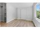 Bedroom with wood flooring, standard closet, and window with greenery view at 2518 S Patton Ct, Denver, CO 80219