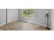 Bedroom with wood flooring, standard closet, and window with greenery view at 2518 S Patton Ct, Denver, CO 80219