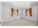 Bright bedroom featuring neutral carpet, two windows, and orange curtains at 2518 S Patton Ct, Denver, CO 80219