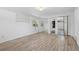 Bedroom with hardwood floors, closet with mirrored doors, and a large window at 2518 S Patton Ct, Denver, CO 80219