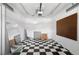 Spacious garage with black and white checkered floor and pegboard walls at 2518 S Patton Ct, Denver, CO 80219