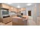 Functional kitchen featuring a center island with cooktop, stainless steel appliances, and bright lighting at 2518 S Patton Ct, Denver, CO 80219