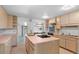 Spacious kitchen with a gas cooktop island and pass through to adjacent room at 2518 S Patton Ct, Denver, CO 80219