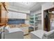 Functional laundry room with cabinets, utility sink, washer, dryer and shelving at 2518 S Patton Ct, Denver, CO 80219