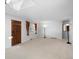 Bright living room with a skylight, neutral carpet, and a large window for plenty of natural light at 2518 S Patton Ct, Denver, CO 80219