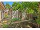 Backyard shed with brick pathway, clean siding, and lush surrounding foliage offers both functionality and charm at 2518 S Patton Ct, Denver, CO 80219