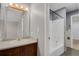 Cozy bathroom features vanity with lighting, tub, and shower with neutral gray walls at 1287 Benton St, Lakewood, CO 80214