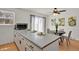 Kitchen featuring a breakfast bar with a dining area, modern appliances, and access to a patio at 1287 Benton St, Lakewood, CO 80214