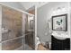 Modern bathroom with a glass-enclosed shower, vanity with mirror, and contemporary fixtures at 2021 Eliot St, Denver, CO 80211