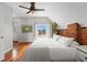 Cozy bedroom with exposed brick accent wall, hardwood flooring, and a picturesque city view at 2021 Eliot St, Denver, CO 80211