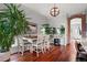Dining room features a modern chandelier, brick archway, and stylish seating for a warm and inviting atmosphere at 2021 Eliot St, Denver, CO 80211