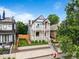 Beautiful two-story home boasts classic architecture, a front yard, and lush green bushes at 2021 Eliot St, Denver, CO 80211