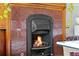 Close-up of a cozy fireplace with a decorative mantel and warm, inviting flames at 2021 Eliot St, Denver, CO 80211