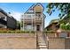 Charming two-story home with a red door, white railings, and beautiful landscaping at 2021 Eliot St, Denver, CO 80211