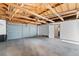 Spacious attached garage with ample room for parking and storage. and doorway to the main house at 2021 Eliot St, Denver, CO 80211
