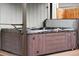This image shows a covered outdoor hot tub with wood paneling at 2021 Eliot St, Denver, CO 80211