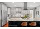 Kitchen with stainless steel appliances, granite countertops, a large center island and grey cabinets at 2021 Eliot St, Denver, CO 80211