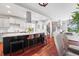 Open concept kitchen with granite countertops, a large island with bar seating and stainless steel appliances at 2021 Eliot St, Denver, CO 80211
