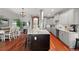 Bright kitchen with a large island, modern appliances, stylish decor and an adjacent dining area at 2021 Eliot St, Denver, CO 80211