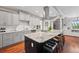 Modern kitchen featuring stainless steel appliances, granite countertops, and a large center island with seating at 2021 Eliot St, Denver, CO 80211