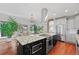 Spacious kitchen features a large island with modern appliances and an eat-in area with lots of light at 2021 Eliot St, Denver, CO 80211