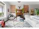 Cozy living room with exposed brick, decorative fireplace, and plush white rug at 2021 Eliot St, Denver, CO 80211