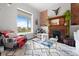 Stylish living room with a fireplace, large window, and city views in the background at 2021 Eliot St, Denver, CO 80211