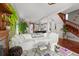 Open concept living room leads to modern kitchen and features wood floors and natural light at 2021 Eliot St, Denver, CO 80211