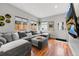 Comfortable living room featuring a large sectional sofa, hardwood floors, and natural light from multiple windows at 2021 Eliot St, Denver, CO 80211