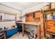 Bright office space with wooden desk, shelving, and a window providing natural light at 2021 Eliot St, Denver, CO 80211