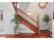Beautiful staircase featuring wooden rails and hardwood floors with decorative mirrors on the wall at 2021 Eliot St, Denver, CO 80211