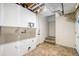 Unfinished basement with open ceiling, exposed ductwork and utility hookups, offering potential for customization at 1915 S Hannibal St # G, Aurora, CO 80013