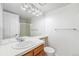 Bathroom featuring a vanity with sink, a large mirror, and a toilet at 1915 S Hannibal St # G, Aurora, CO 80013