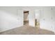 Bedroom with carpet, white walls, view of the bathroom, and closet space at 1915 S Hannibal St # G, Aurora, CO 80013