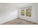 Bright bedroom with neutral carpet, white walls, and large windows bringing in natural light at 1915 S Hannibal St # G, Aurora, CO 80013