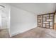 Bonus room with carpet, white walls, built-in shelves, and access to a bathroom at 1915 S Hannibal St # G, Aurora, CO 80013