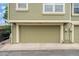 Home featuring a two-car garage and olive green siding at 1915 S Hannibal St # G, Aurora, CO 80013