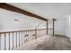Loft space featuring wooden beams, a wooden railing, and skylights at 1915 S Hannibal St # G, Aurora, CO 80013