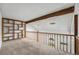 Loft space featuring wooden beams, a wooden railing, built-in shelves, and skylights at 1915 S Hannibal St # G, Aurora, CO 80013