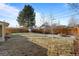 Spacious backyard with fire pit, storage shed, and mature trees at 2885 Hudson St, Denver, CO 80207